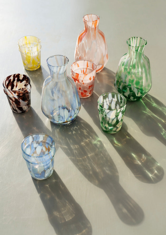 assorted coloured hand blown drinking glasses in different tones
