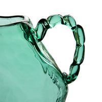 Close-up of twisted, gem-like glass handle on green amphora vase