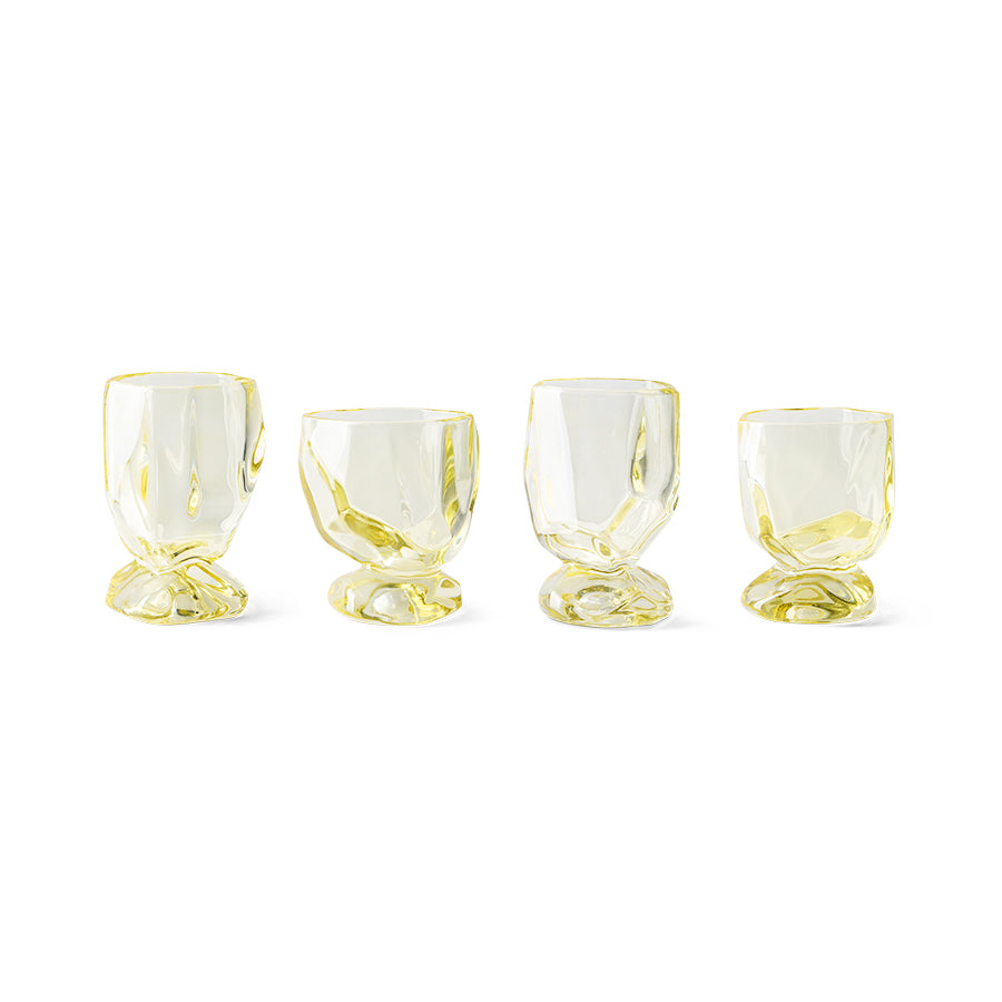 The full set of four HKLIVING Citrine glasses lined up on a plain white background, showing their faceted, gem-like silhouette