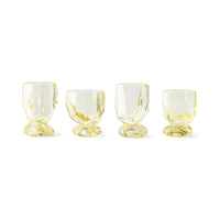 The full set of four HKLIVING Citrine glasses lined up on a plain white background, showing their faceted, gem-like silhouette