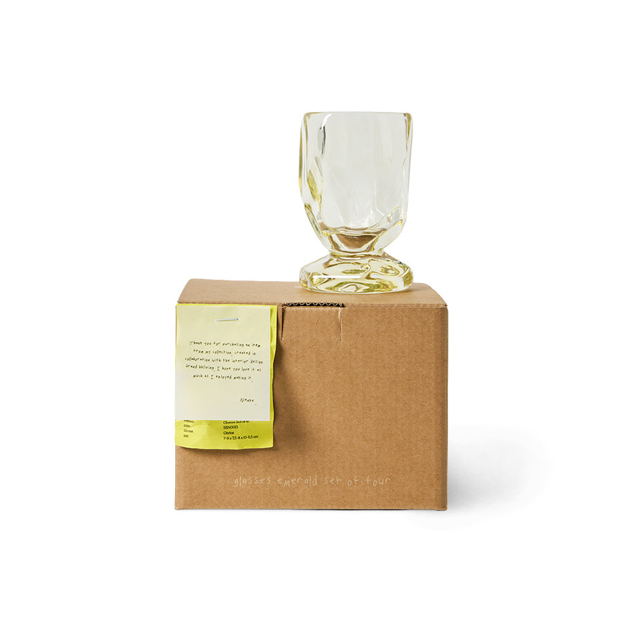 A single HKLIVING Citrine glass displayed on top of its branded gift box on a plain white background, with a handwritten note from the designer visible on the box
