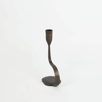 Steffi 30 cm cast iron candle holder by Olsson & Jensen from an angle, showing the curved stem and pebble base