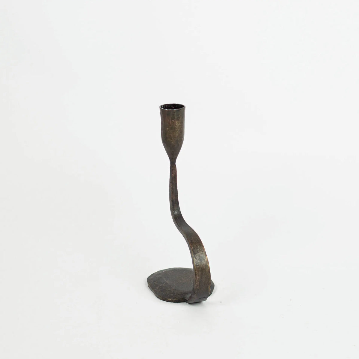 Steffi 30 cm cast iron candle holder by Olsson & Jensen from an angle, showing the curved stem and pebble base