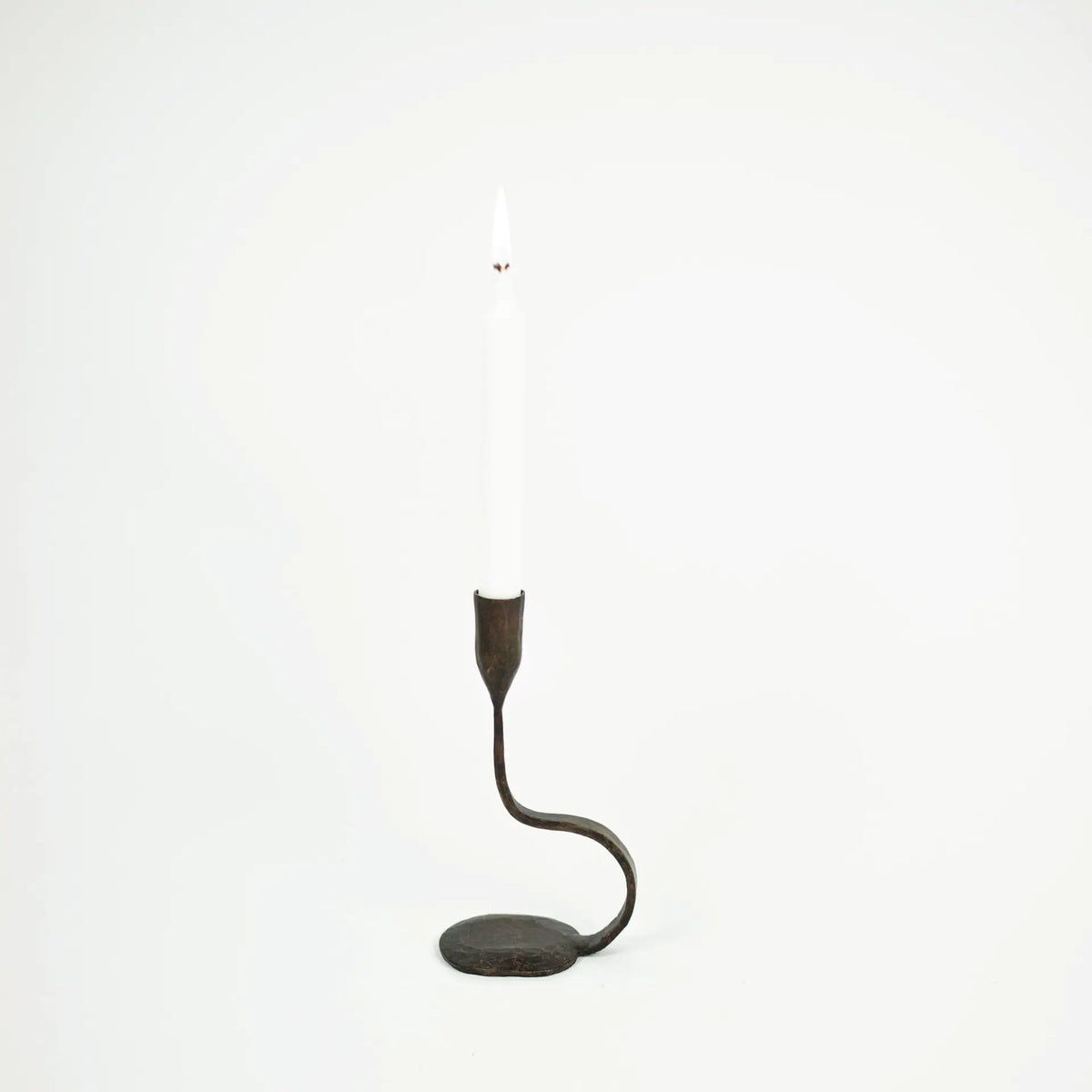 Steffi 22 cm black cast iron taper candle holder by Olsson & Jensen holding a white dinner candle