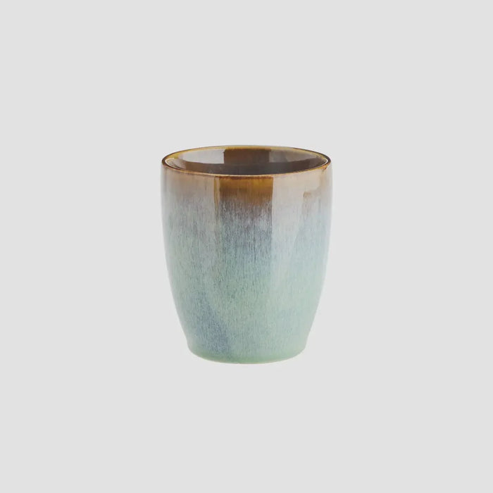 light green and brown stoneware cup by Madam Stoltz with artisan glaze
