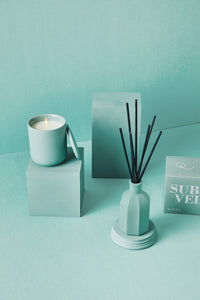 Sublime Velvet ceramic candle with matching box and reed diffuser in soft aqua tones
