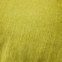 Close-up of woven linen texture on lemongrass yellow cushion