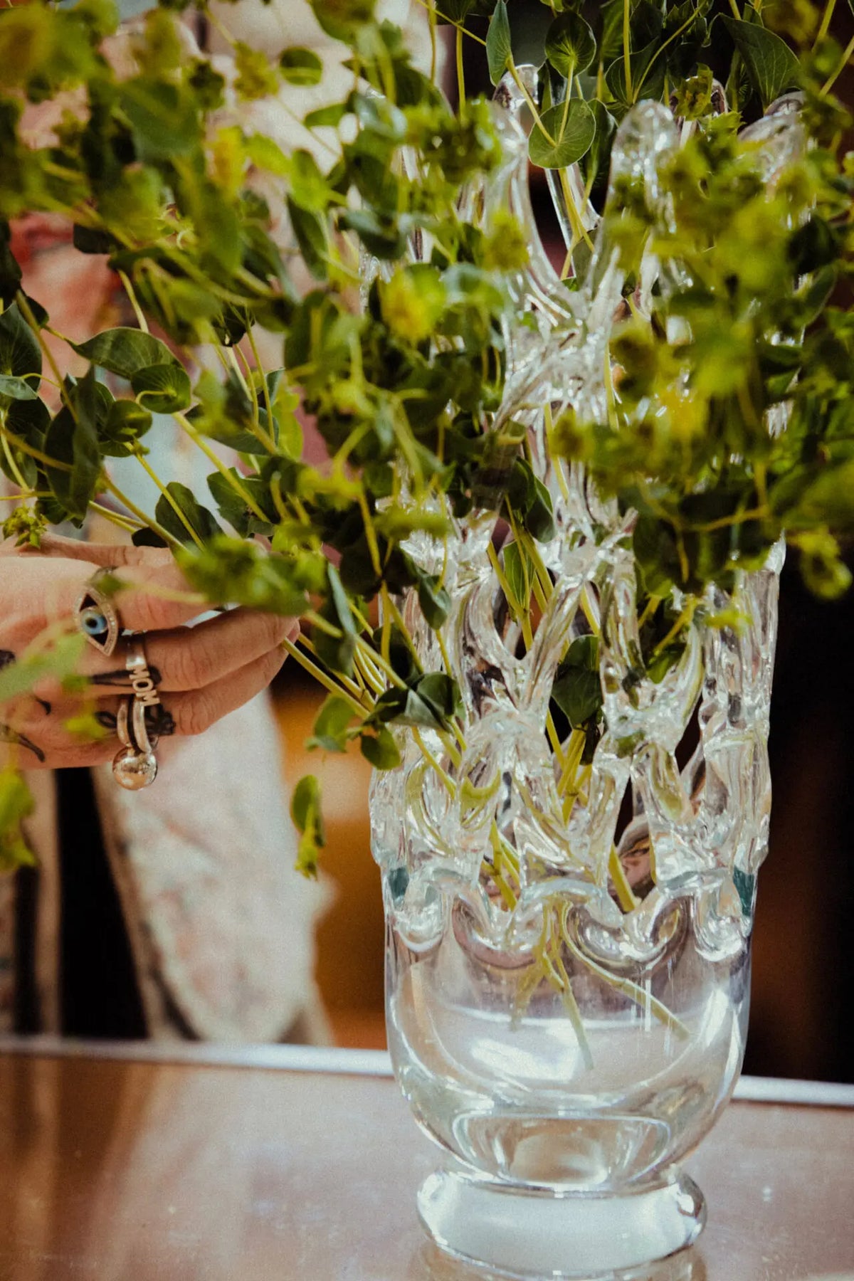 Timantti glass vase by Olsson & Jensen filled with green foliage