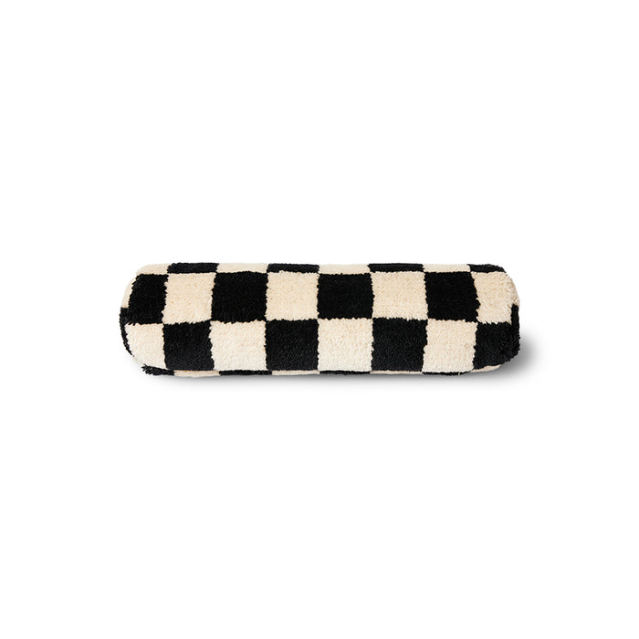 black and white chequered fluffy woollen bolster cushion. cylindrical in shape for perfect lumbar support