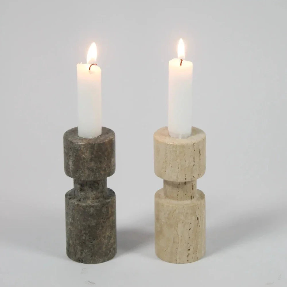 Dark and light asymmetric travertine candle holders by Olsson & Jensen with lit candles