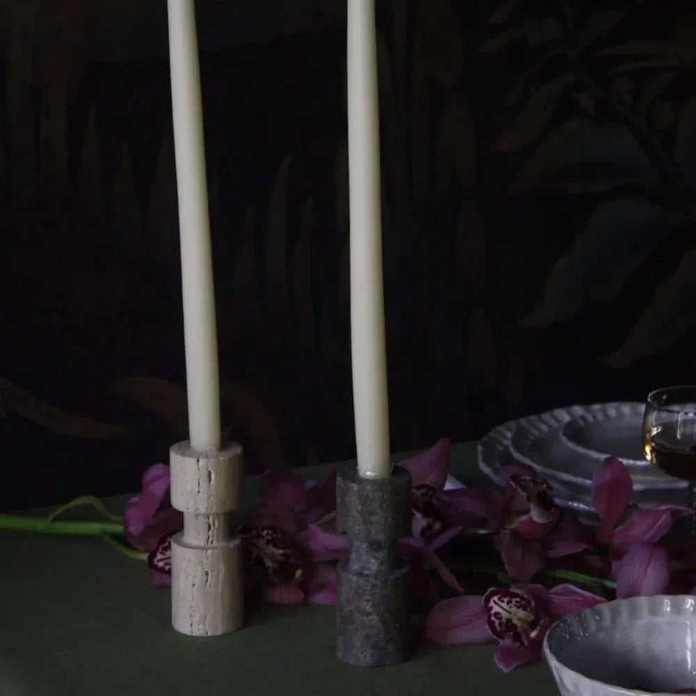 Travertine candle holders by Olsson & Jensen styled with purple flowers