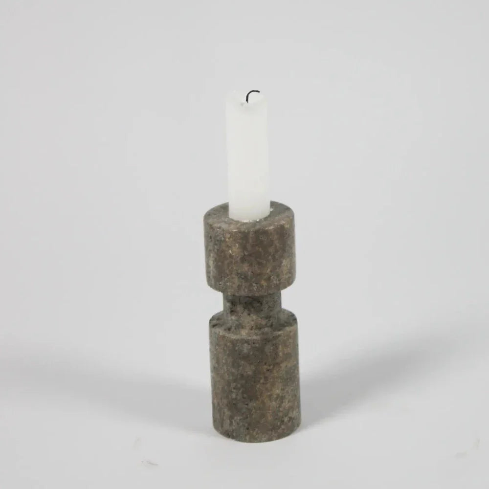 Dark travertine asymmetric candle holder by Olsson & Jensen with a white candle