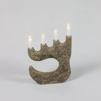 Travis travertine four-arm candle holder by Olsson & Jensen with lit candles
