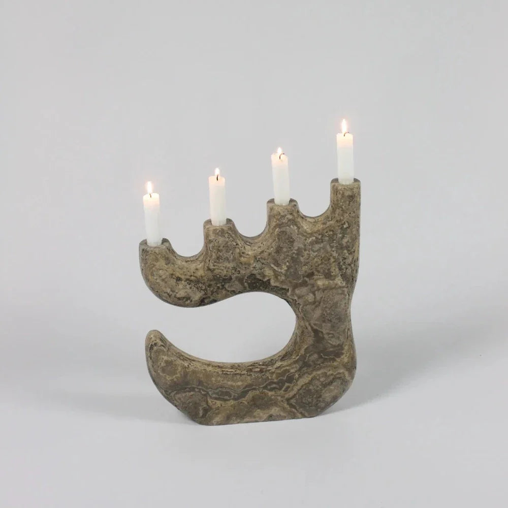 Travis travertine four-arm candle holder by Olsson & Jensen with lit candles