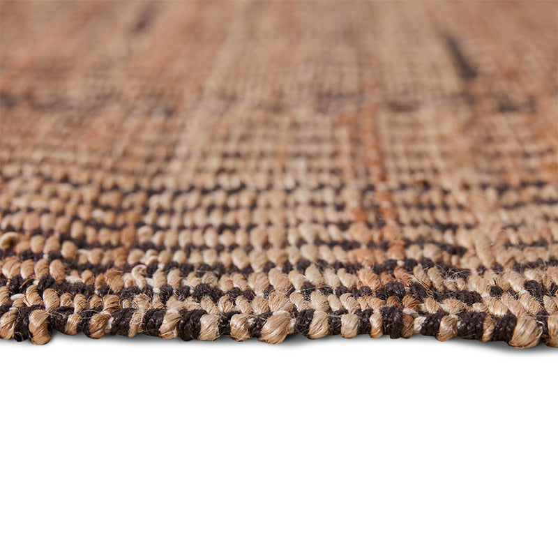 close up of side and edge view of a natural textural rug in scandi style from design house of hk living