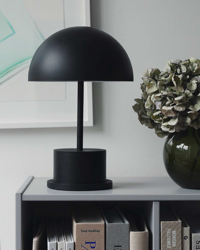 modern black portable lamp adding soft light to a contemporary interior
