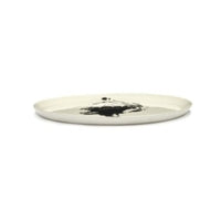 side view of an off white serving dish with a black artichoke motif by ottolenghi and with a visible quality bby serax dinnerware