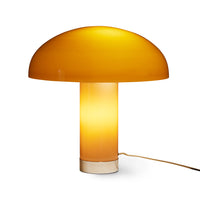 switched on, the mocha lamp glows from both within the lamp shade and its mushroom stalk in a golden yellow orange, with the HKLIVING logo shown in the chrome base
