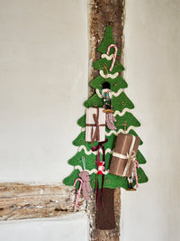 Felt Christmas tree wall hanging with small gifts and nutcracker ornaments