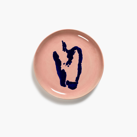 gorgeous heavily glazed delicious pink side plate with a deep blue bell pepper desigb motif by ottolenghi covering the plate bringinig funa nd joy to any feast or dinnerparty with friends and revelling in the quality finish of serax