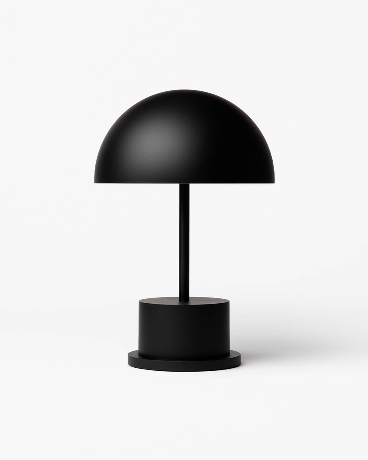 matte black portable Riviera lamp with dome shade and cylindrical base
