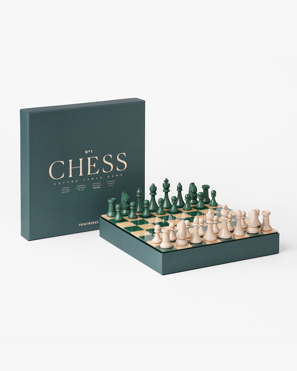Wooden chess pieces on green and cream board styled to look like coffee table book