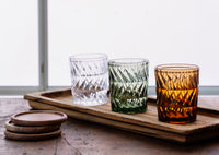 long wooden tray styled with textured drinking glasses on rustic surface