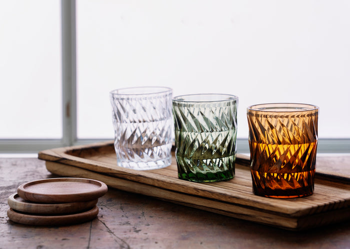 long wooden tray styled with textured drinking glasses on rustic surface