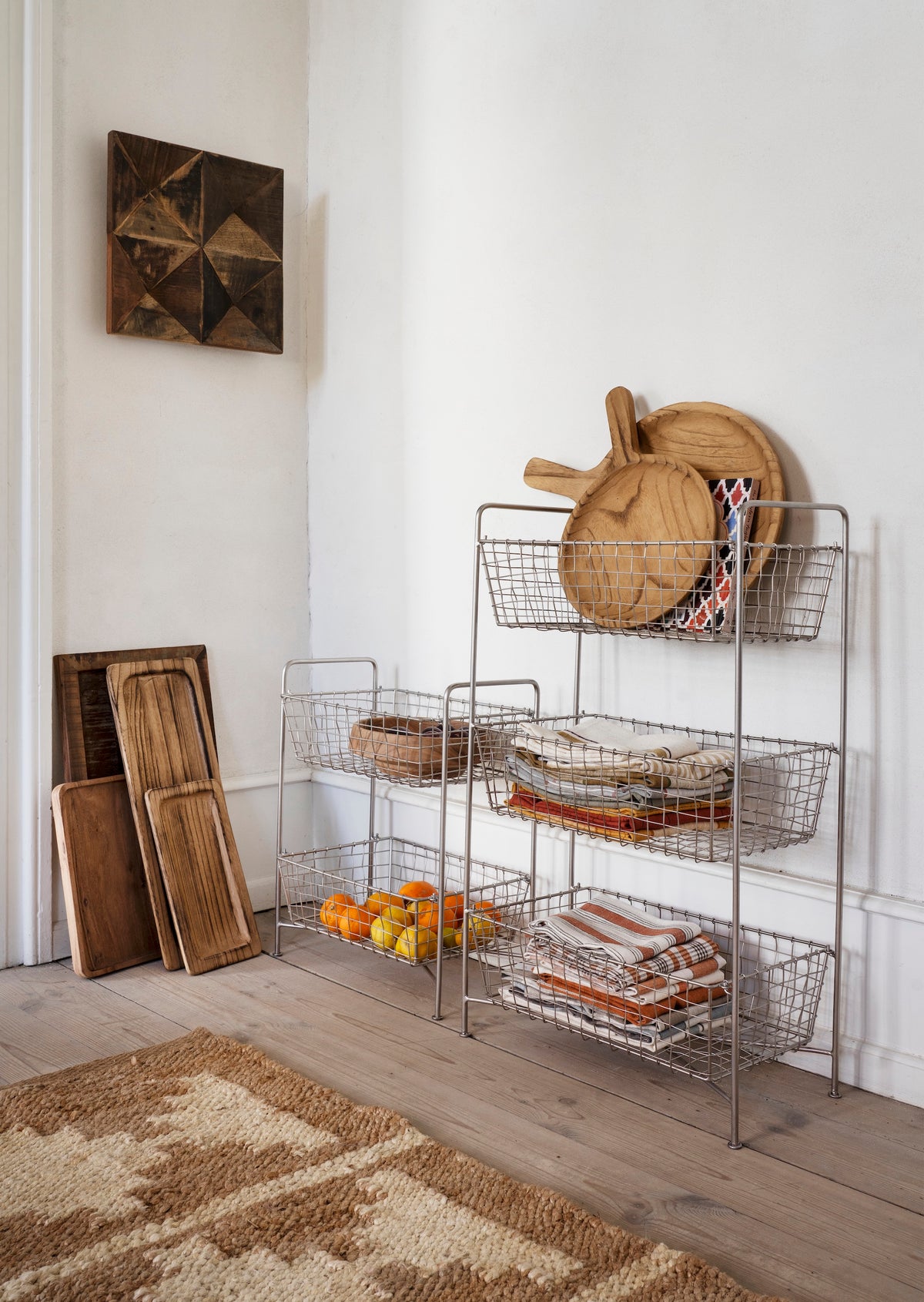rustic wooden trays styled in a warm nordic kitchen with baskets and natural textures