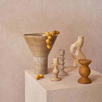 Yaro vase with dried flowers styled on a plinth with sculptural candle holders
