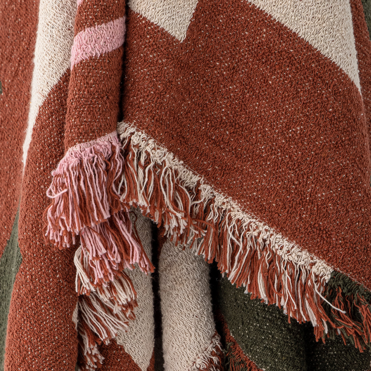 close up texture of york throw with woven geometric pattern and fringed edge