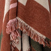 close up texture of york throw with woven geometric pattern and fringed edge