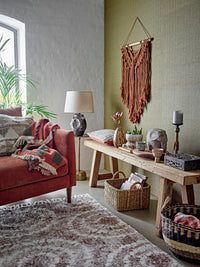 cosy living room with brown geometric recycled cotton throw draped over terracotta sofa
