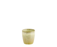 Green ceramic cup on a white background