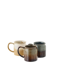 multi-coloured stoneware mugs with artisan glaze, three variants side by side
