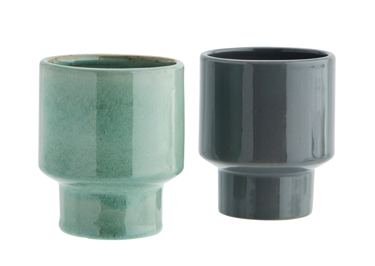 green and grey stoneware cups with modern silhouette and smooth glaze finish, side by side

