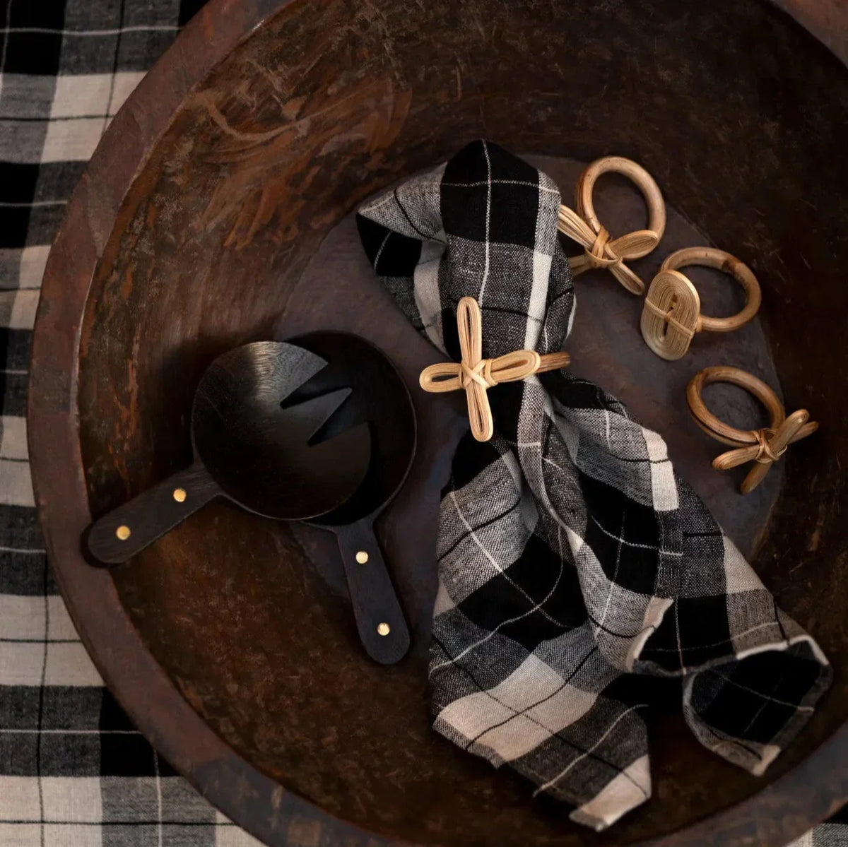 Zen salad servers by Olsson & Jensen styled in a wooden bowl with a checked napkin