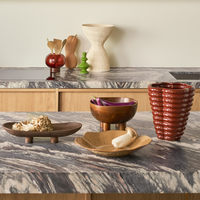 Zeno bowl on a marble kitchen worktop with ceramics and a ribbed vase