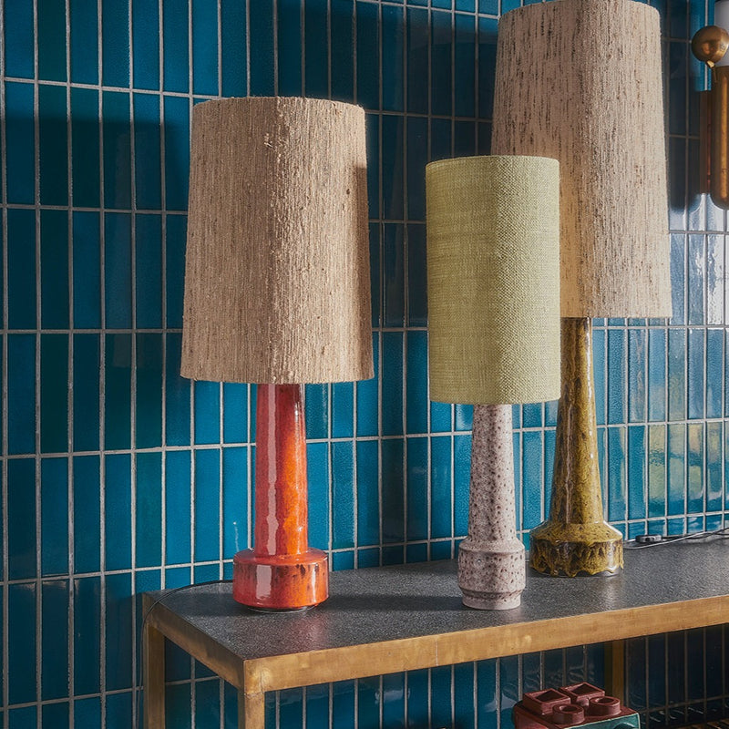 mismatched lamps and lamp shades from different collections from hkliving stand in front of a blue tiled wall