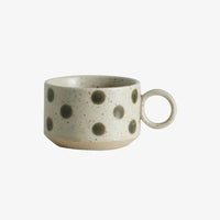 the little cup, that a light green with darker green spots dotted sparingly accross its surface