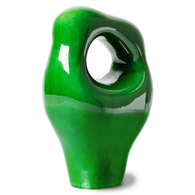bright glossy green hkliving object in a very 70s style to bring drama to a mantlepiece and room