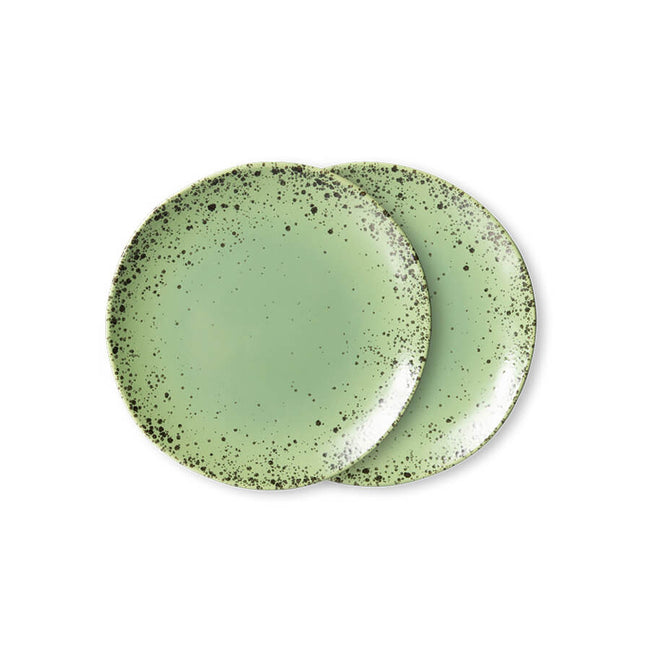 kiwi green plates with dark seed like speckles appearing more heavily around the edge from hk living 70s collection