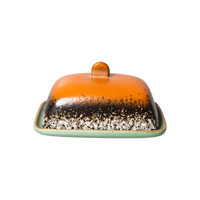 meteor butter dish with it's orange top and green base plate