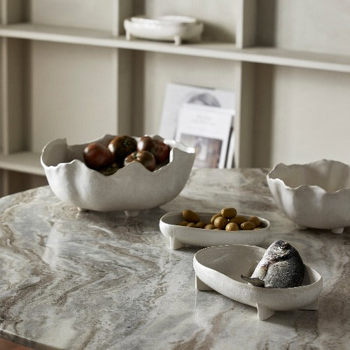 collection of decorative bowls on a grey marble table