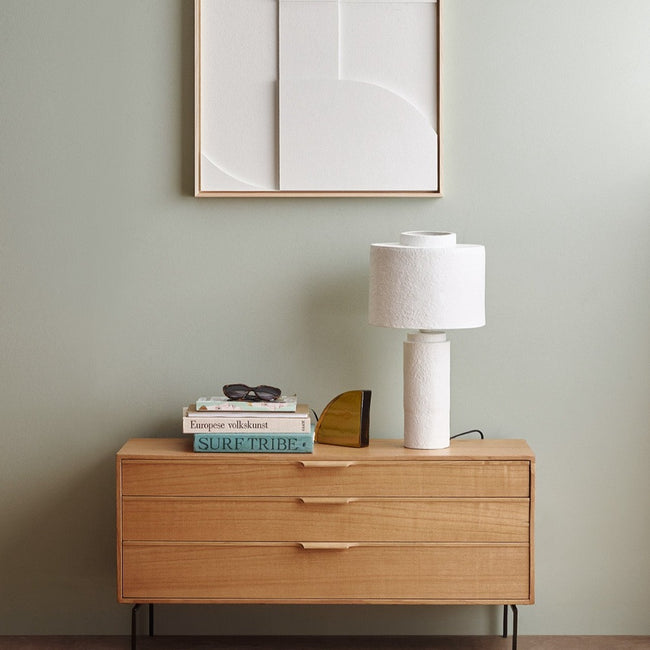 white lamp on a chest of drawers adding a real texture to the bedroom and a little drama from hkliving