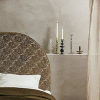 Candle holders next to a bed